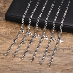 Six silver Cuban link initial bracelets with letters J, N, M, Q, B and A lying flat