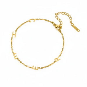 Gold multiple initials bracelet with five letters and an extender chain lying flat