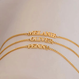 Three gold capital letter name bracelets with the names MELANIE, OLIVER and PENNY