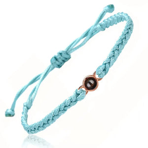 Light blue braided adjustable cord bracelet with a rose gold photo projection stone