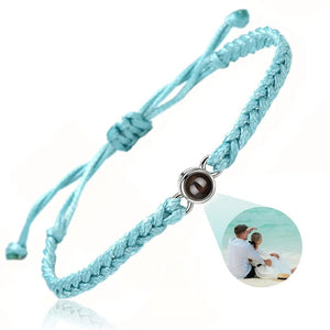 Light blue braided photo projection bracelet with a silver setting and couple photo