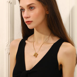 Woman wearing Bold Bubble Initial Pendant Necklace Gold M