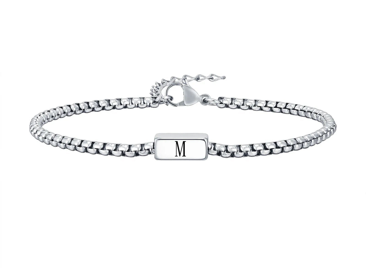 Silver box chain bracelet with a rectangular bar engraved with the initial M