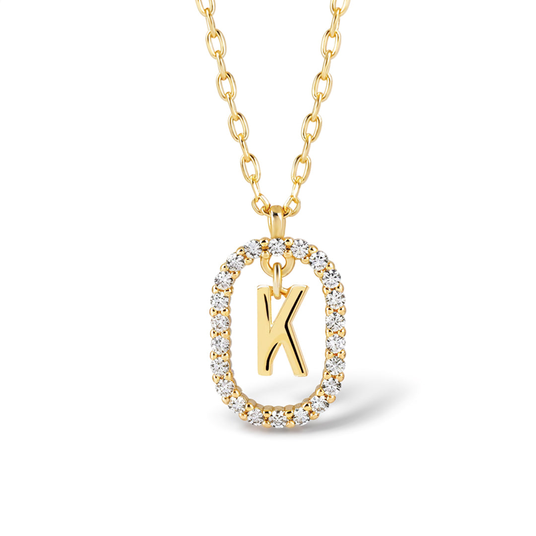 Gold circle initial necklace with the letter K in a crystal-set oval frame