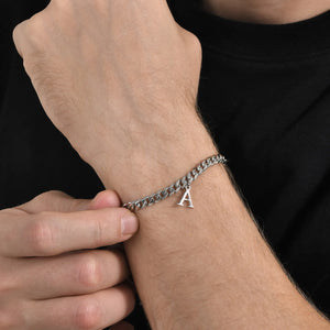 Silver Cuban link initial bracelet with the letter A worn on the wrist