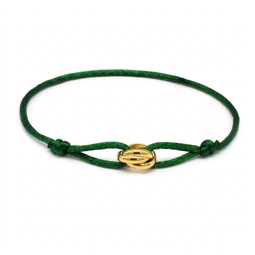 Green bracelet with a gold clasp on a white background