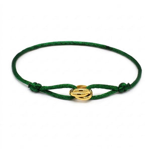 Green bracelet with a gold clasp on a white background