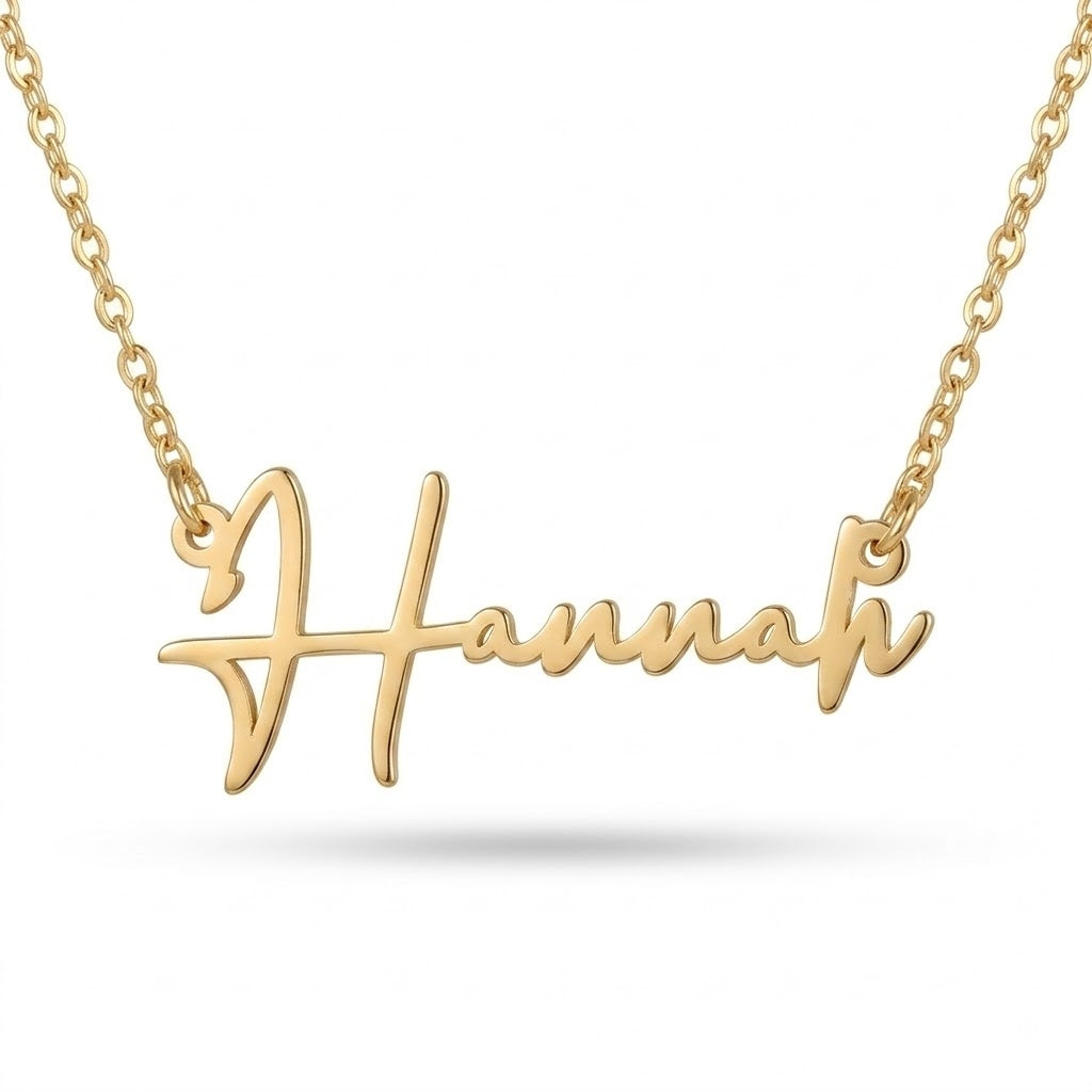 Gold handwritten name necklace with the name Hannah in flowing script on a cable chain