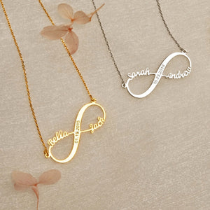 Gold and silver infinite love necklaces with engraved names lying flat