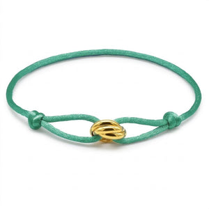Jade bracelet with a gold clasp on a white background