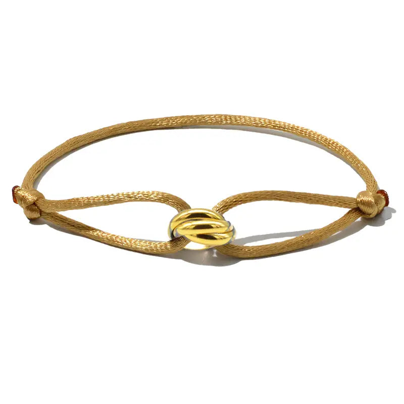 Khaki beaded rope bracelet with a gold knot design on a white background