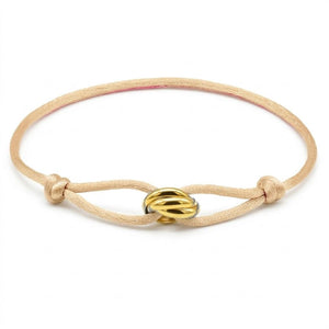 Beige bracelet with a gold clasp on a white background