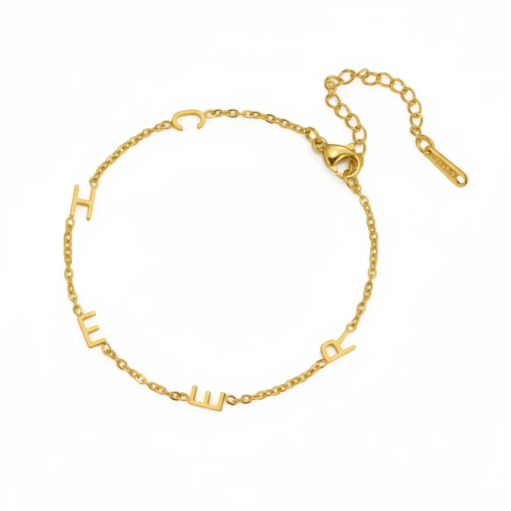 Gold multiple initials bracelet with five letters and an extender chain lying flat