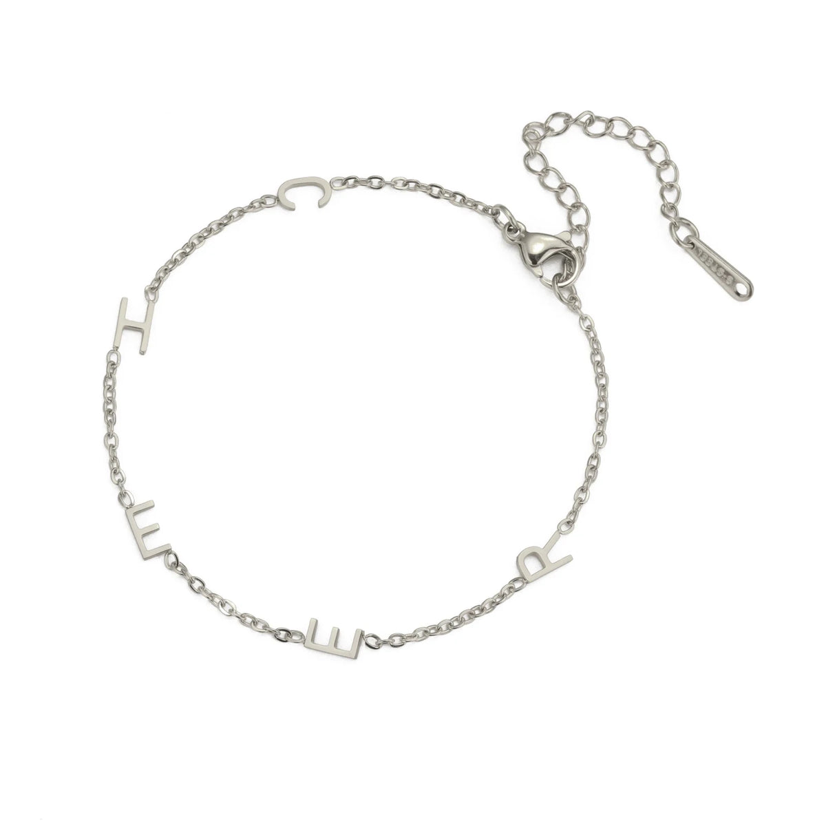 Silver multiple initials bracelet with five letters and an extender chain lying flat