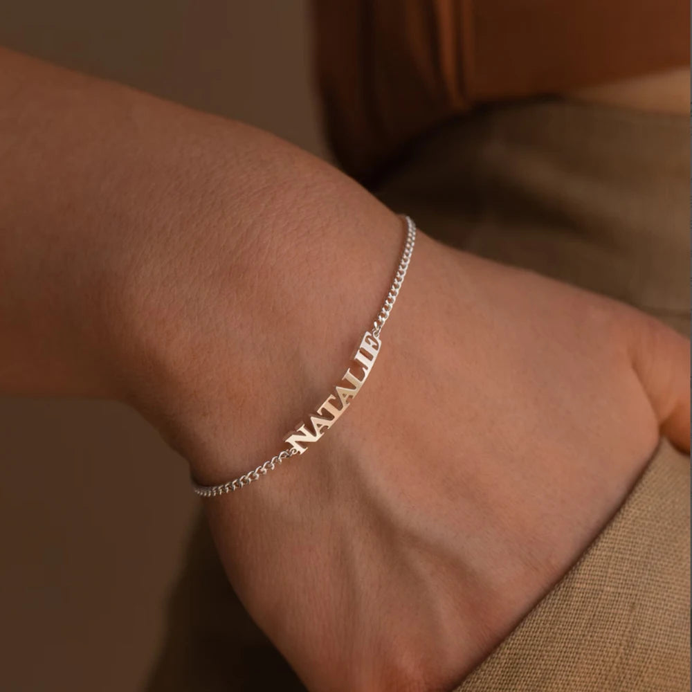 Silver capital letter name bracelet with the name NATALIE worn on the wrist