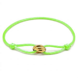 Neon green bracelet with a gold clasp on a white background