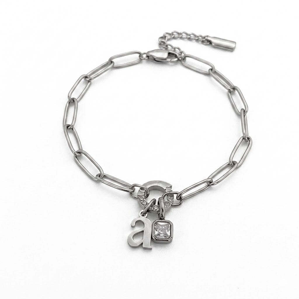 Silver paperclip birthstone initial bracelet with the letter a and a clear square stone