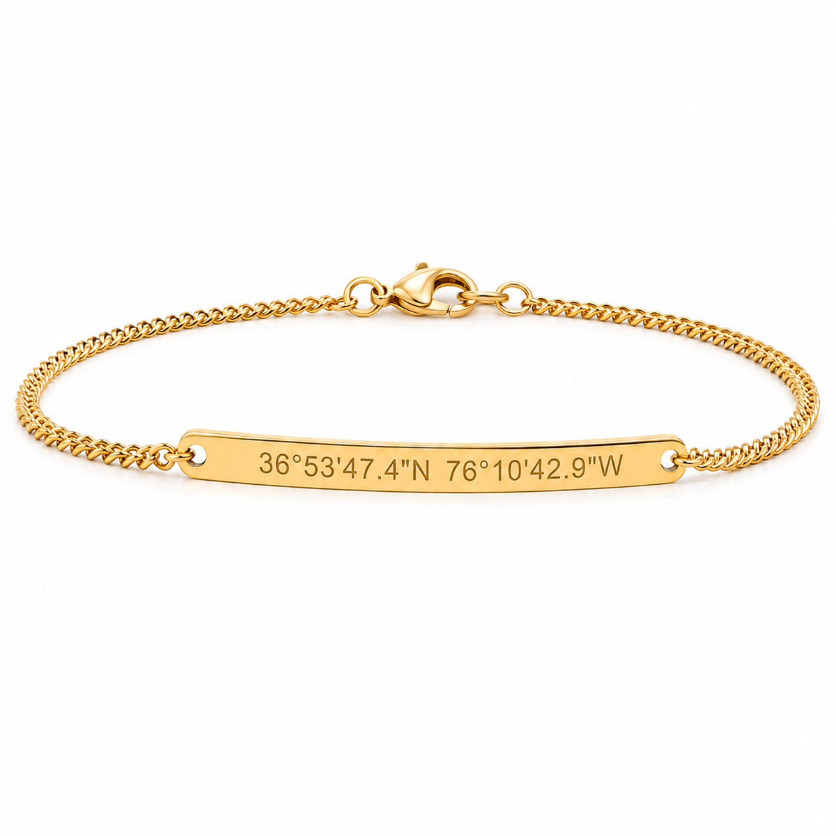 Gold engraved bar bracelet with coordinates 36°53'47.4"N 76°10'42.9"W on a curb chain
