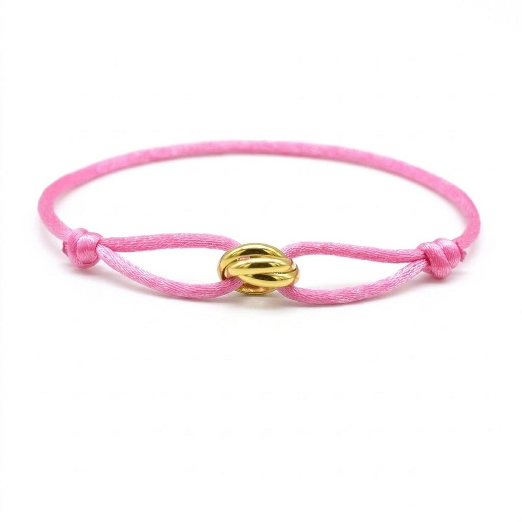 Pink bracelet with a gold clasp on a white background