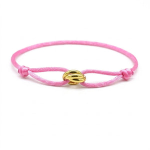 Pink bracelet with a gold clasp on a white background