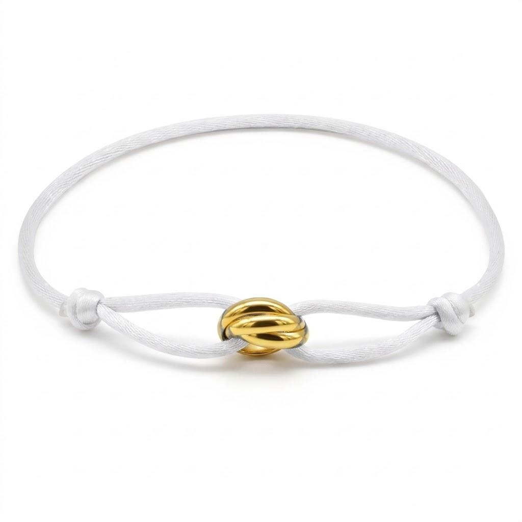 White bracelet with a gold knot charm on a white background