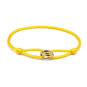 Yellow bracelet with a gold clasp on a white background