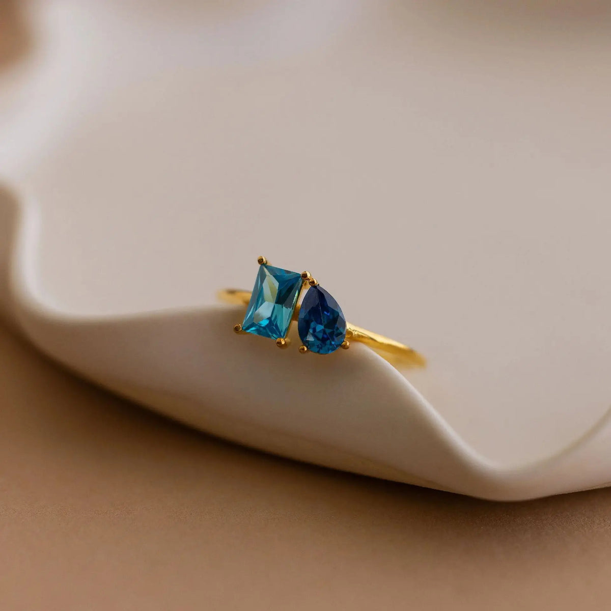 Gold You & Me double birthstone ring with light and dark blue stones